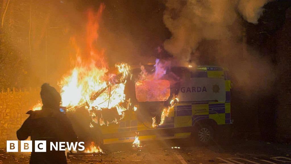 Police van set on fire at protest outside asylum seeker hotel